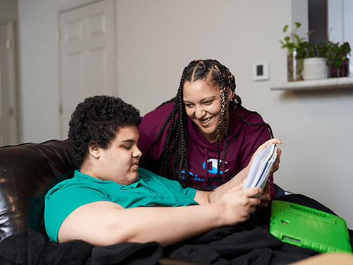 A long-term care worker smiling at her place of work