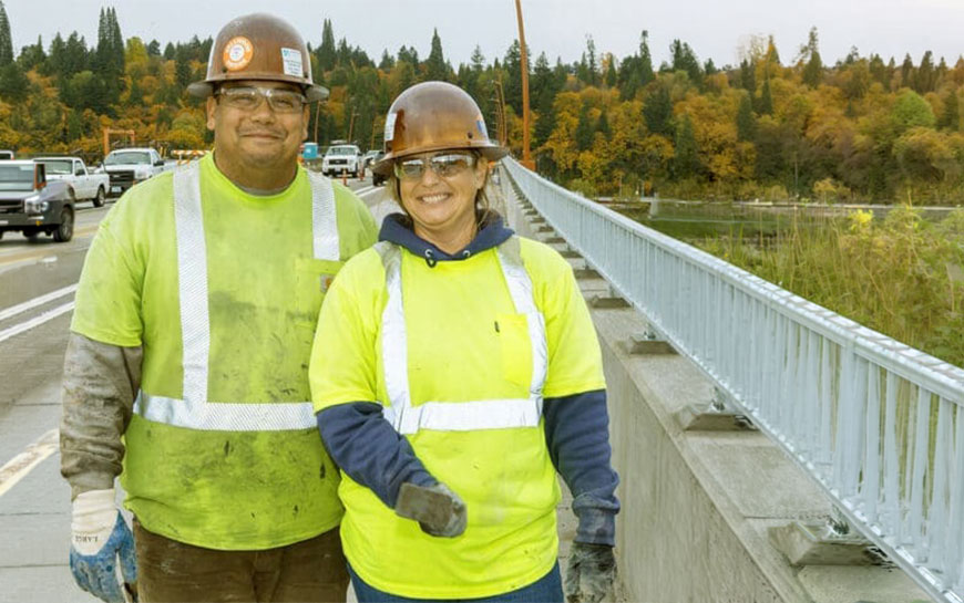 Smiliing ODOT workers standing on an expressway