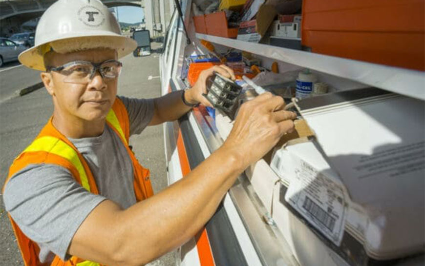 ODOT Electrician reaching in to a truck mounted toolbox