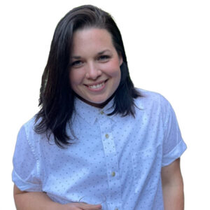 Sarah Edwards, with shoulder-length dark hair, smiles toward the camera while wearing a white button-down shirt with tiny dots.