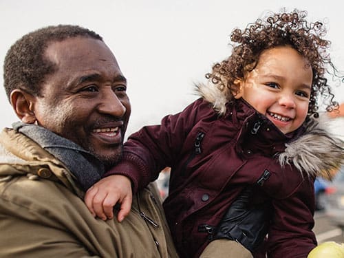 A homecare worker and his and child enjoying a day outside