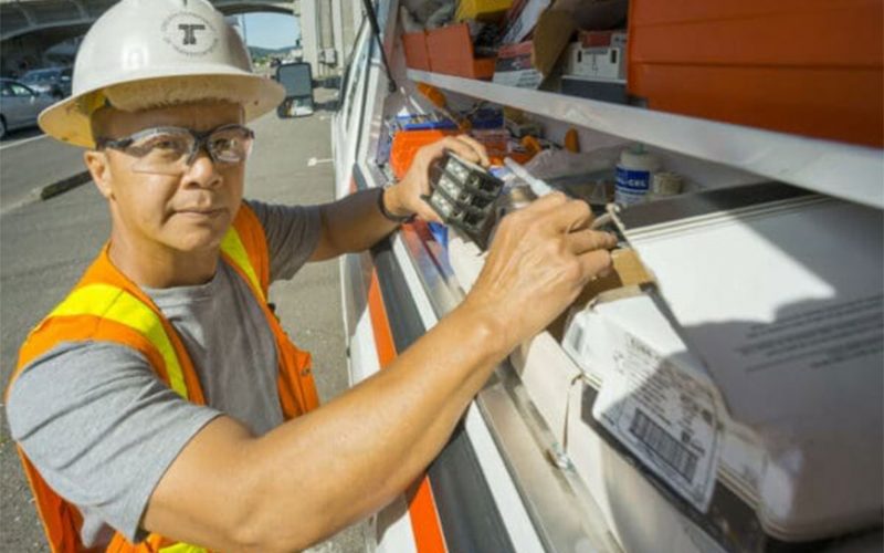 ODOT Electrician reaching in to a truck mounted toolbox