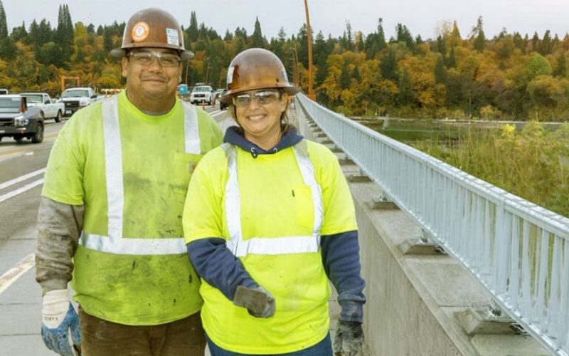 Smiliing ODOT workers standing on an expressway